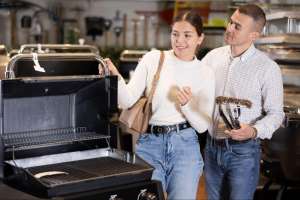 Photo of a couple browsing gardening supplies in a store, examining items on a display shelf as they look for the best gardening gifts for women. Photo of a couple browsing gardening supplies in a store, examining items on a display shelf as they look for the best gardening gifts for women.